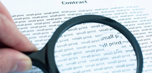 Magnifying glass looking at words "small print"