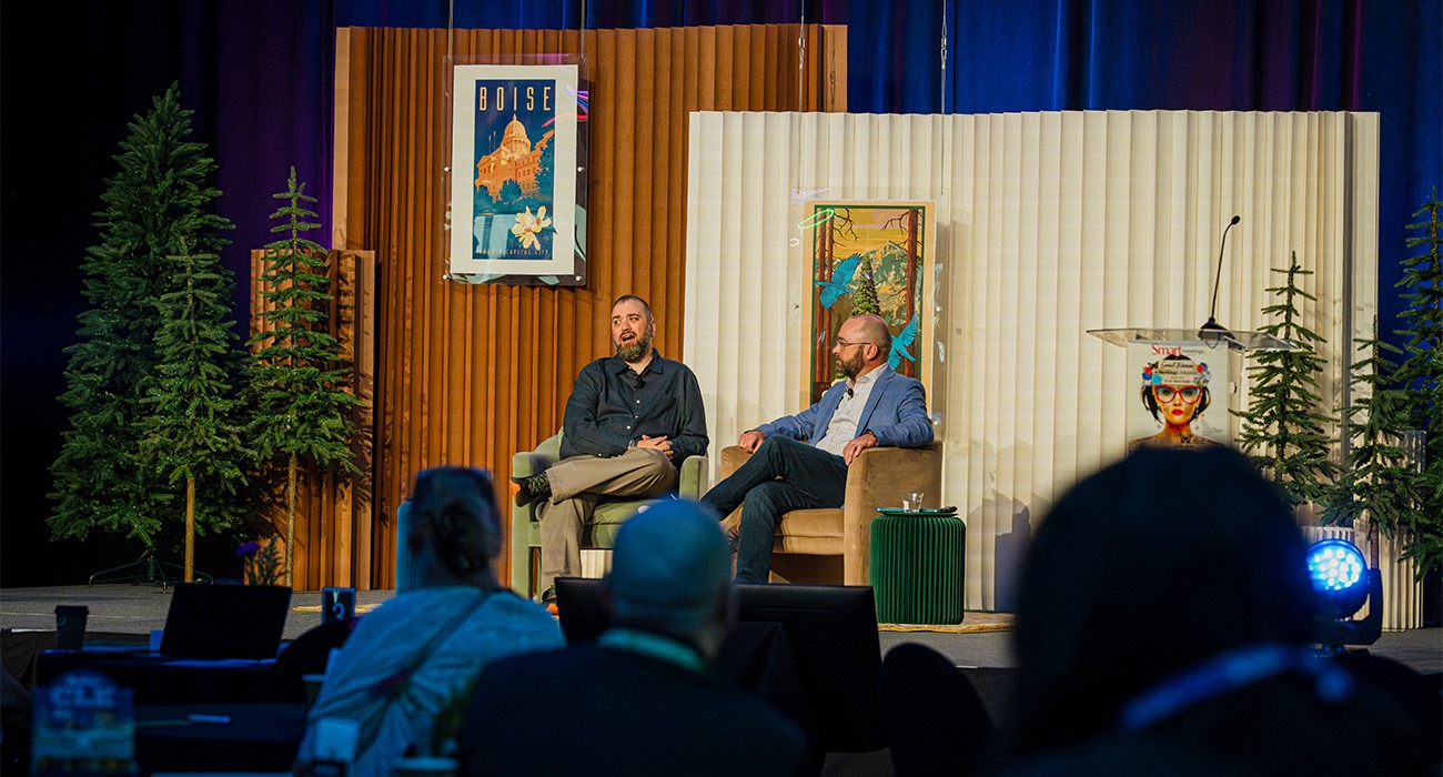 Two men talking on stage