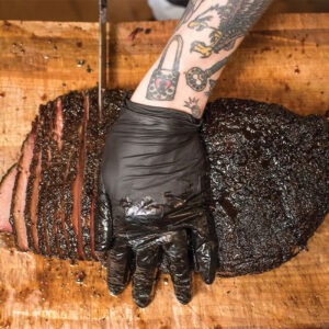 Person cutting beef