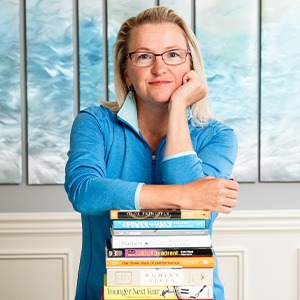Gina Cotner resting elbows on books