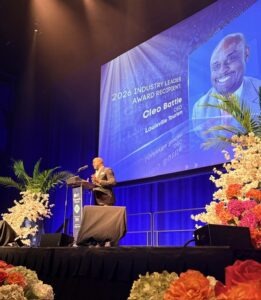 Cleo Battle on stage accepting award