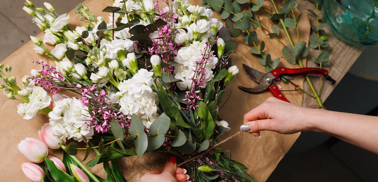 Person creating bouquet