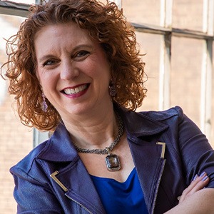 Lisa Ryan crossing arms in denim coat