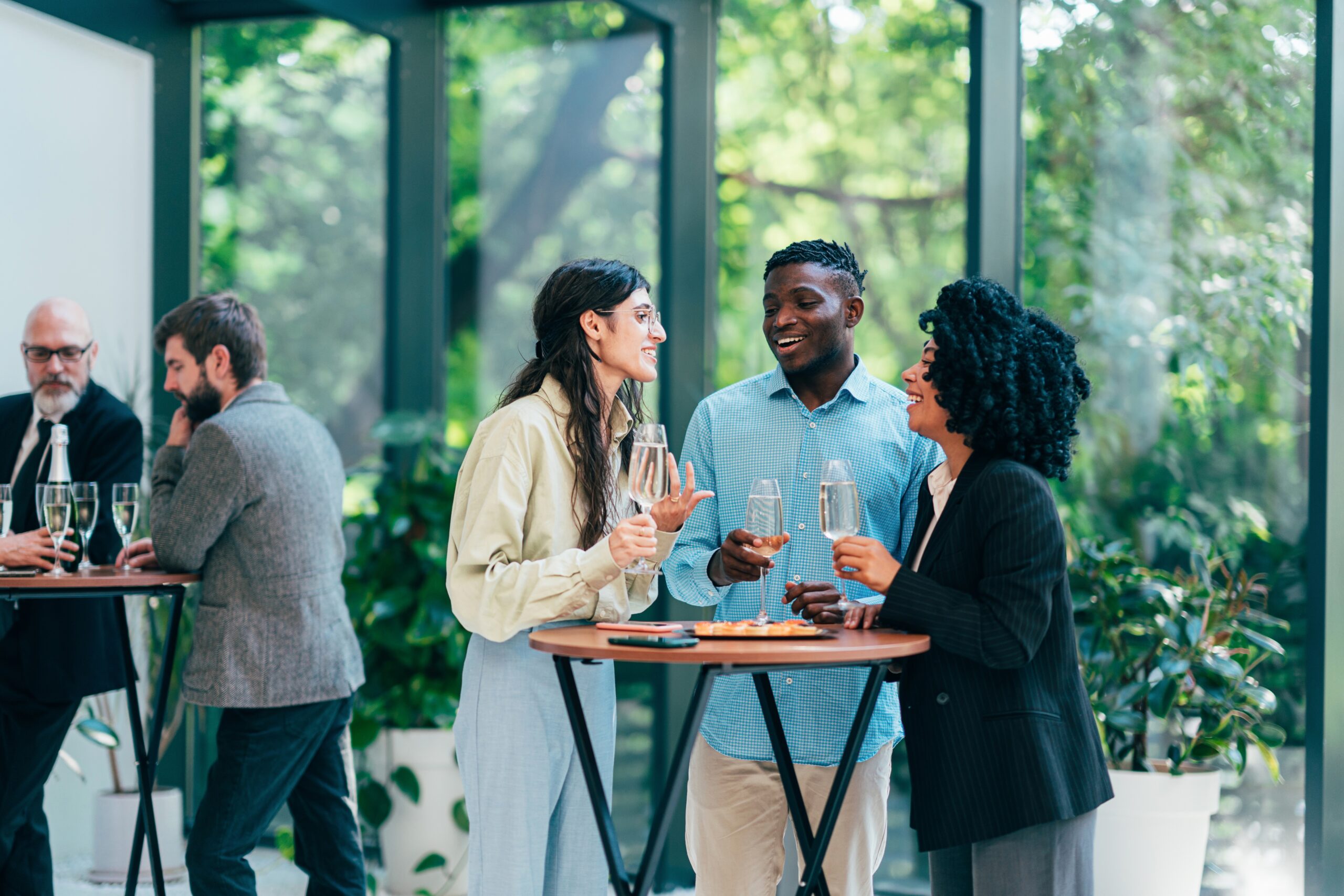 People gatering around a table at an event, connecting
