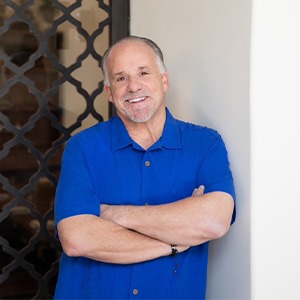 Jon Benson wearing blue shirt with arms folded