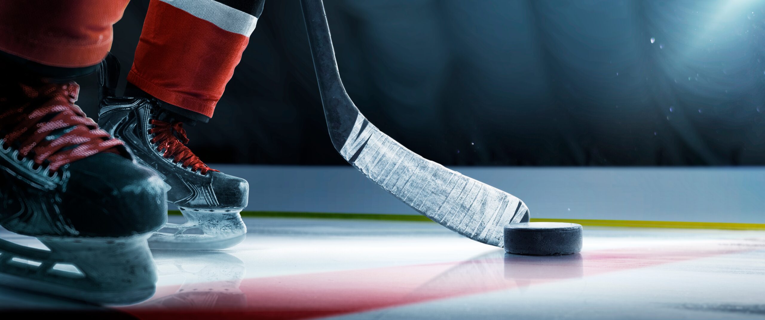 Hockey player with hockey stick and puck