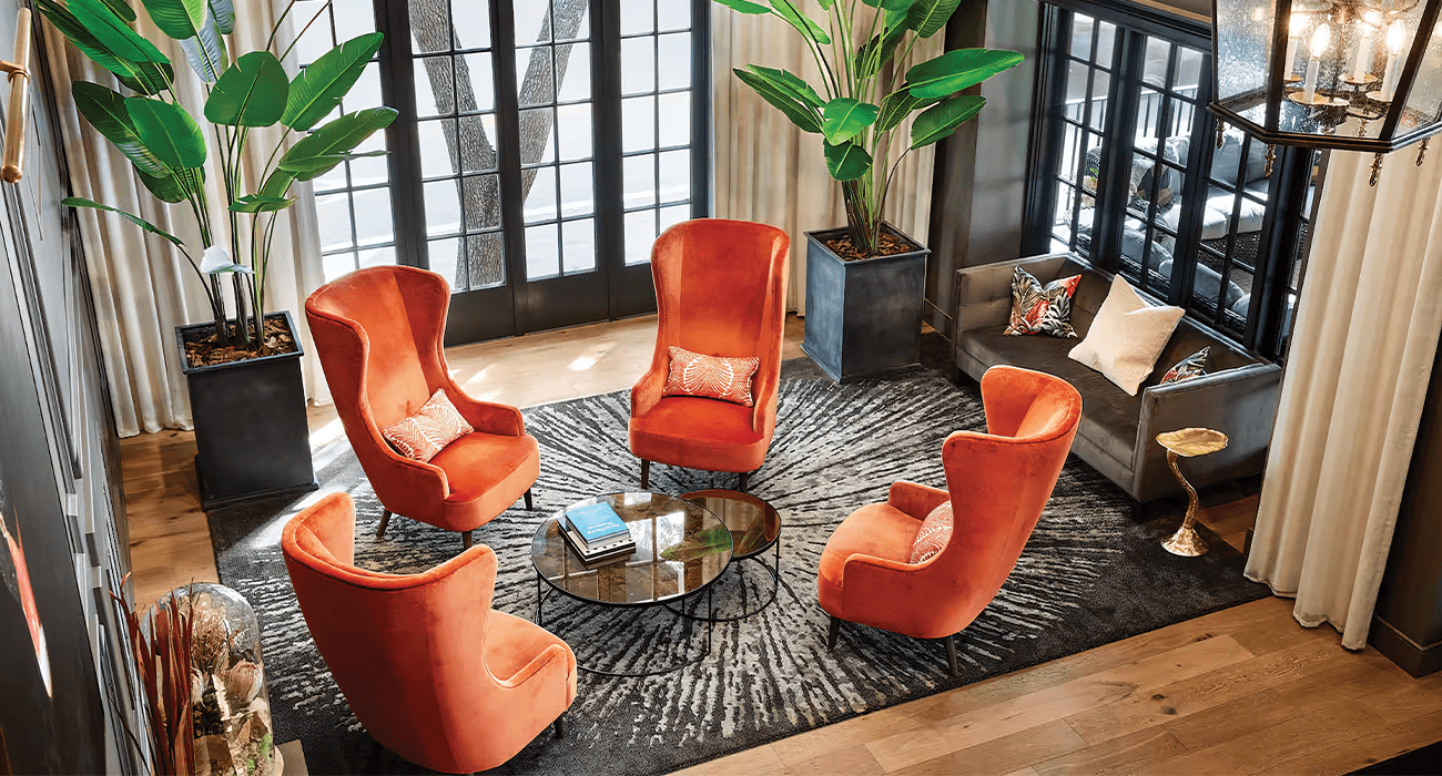 Four orange chairs in a circle in hotel lobby