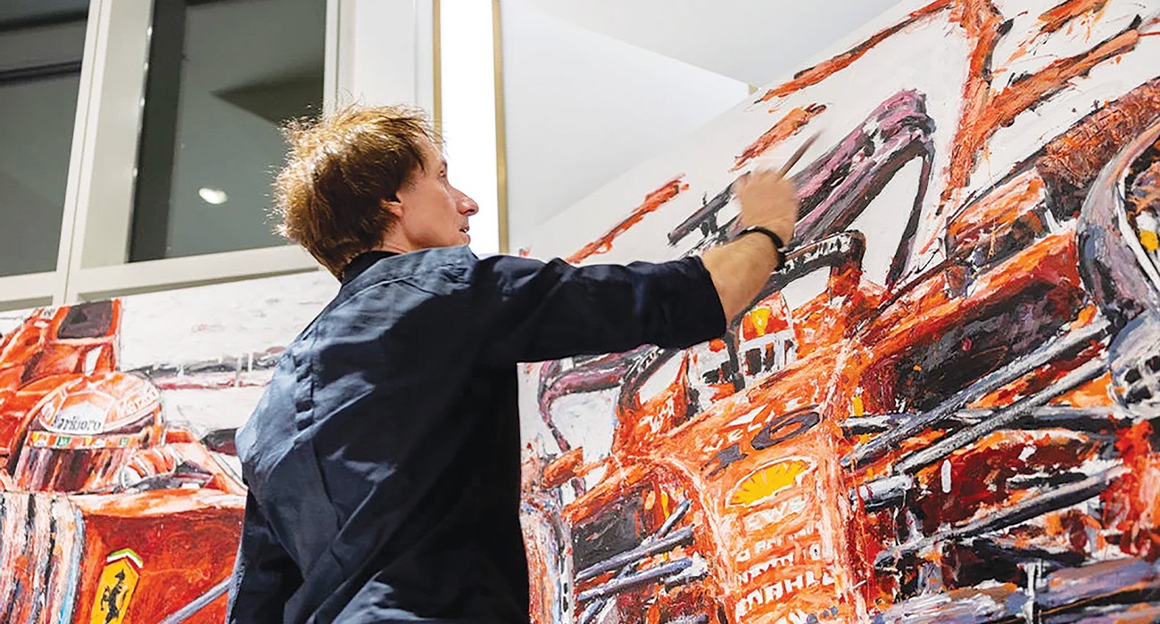 A man painting a picture of car
