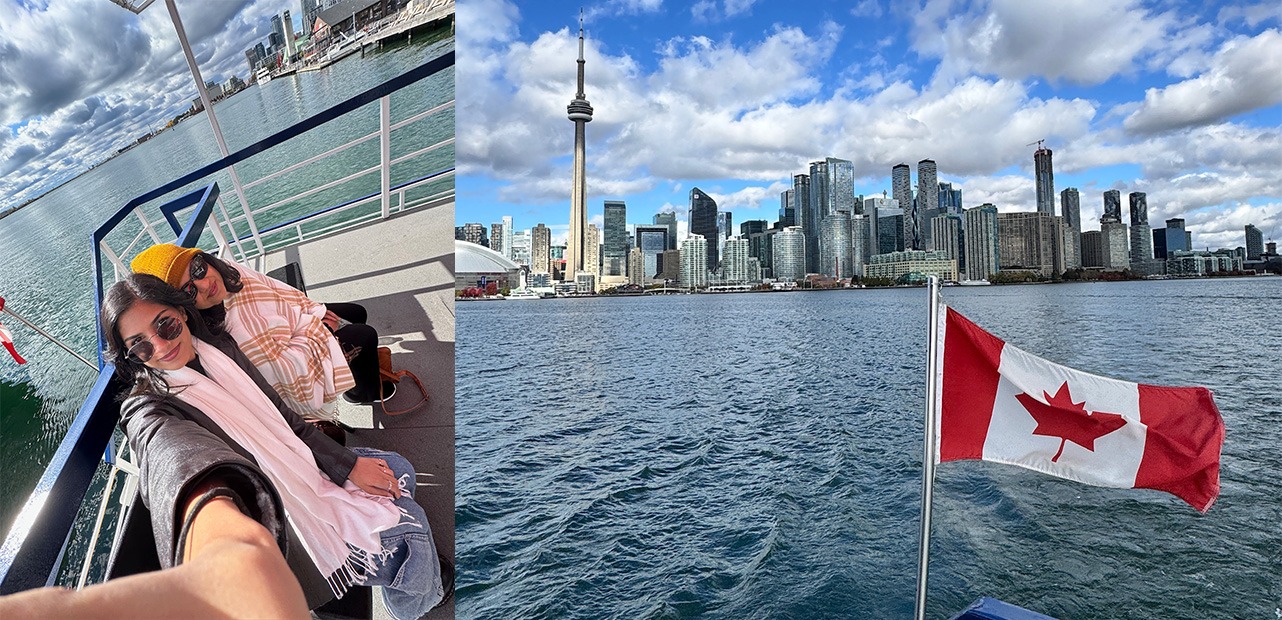 Two women taking selfie next to Canadian flag