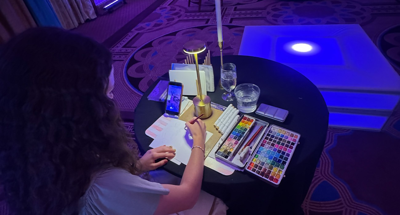 Woman painting picture from phone