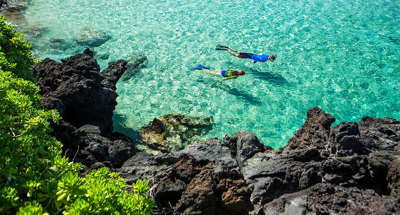 People swimming at Mauna Kea Beach Hotel