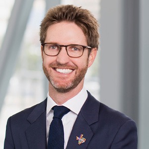 Man with glasses in blue suit