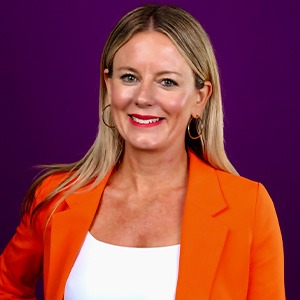 Tracy Judge wearing orange sport coat