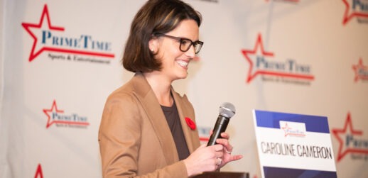 Woman holding microphone in hand on stage
