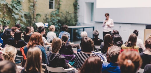 Female speaker talking in front of crowd