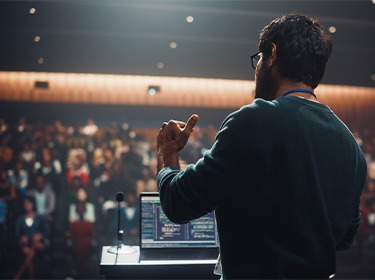 Man speaking in front of seated audience