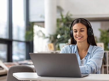 Woman watching a webinar on a laptop