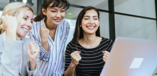 Women in front of computer celebrating