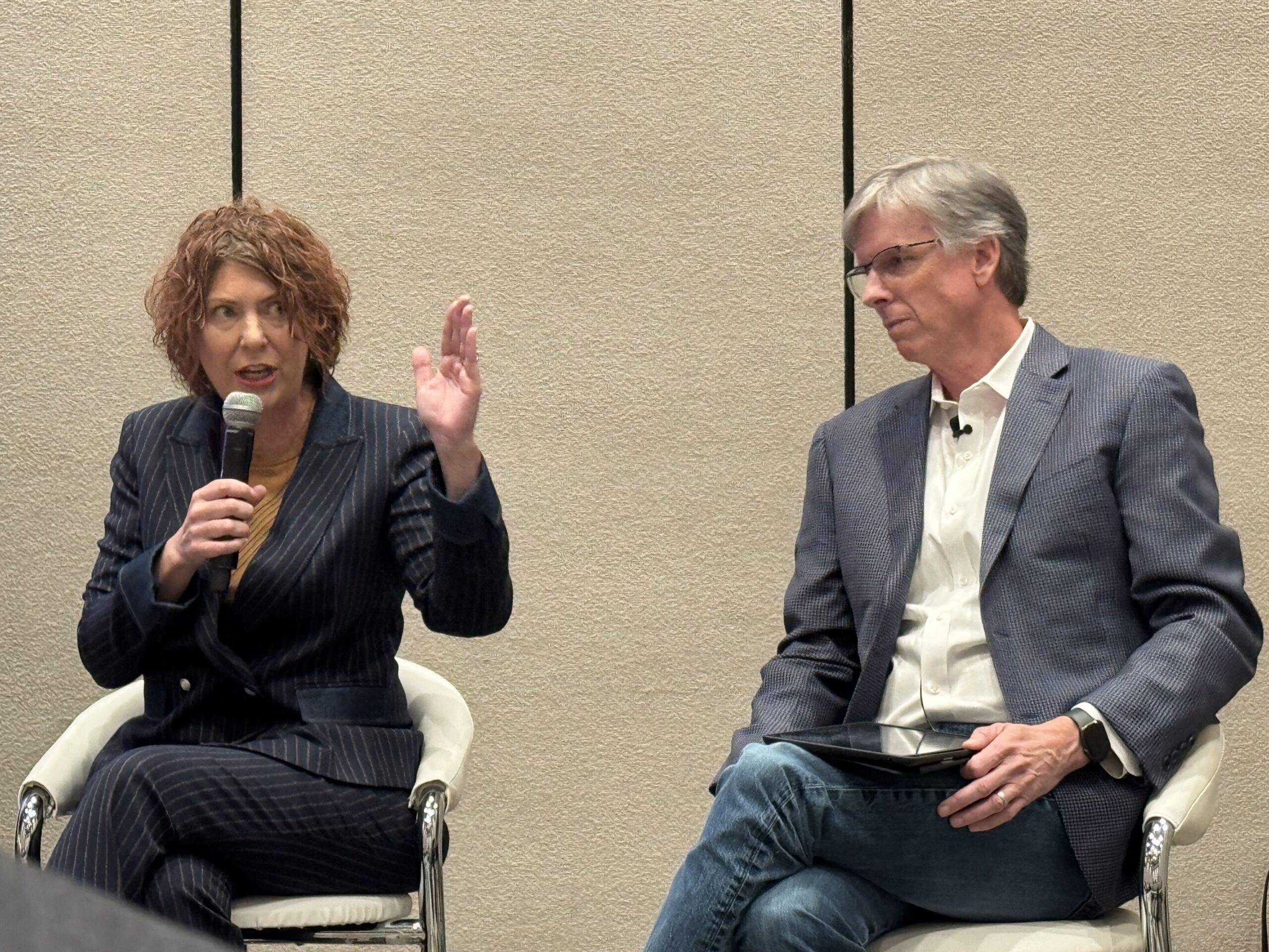 Two people talking on stage