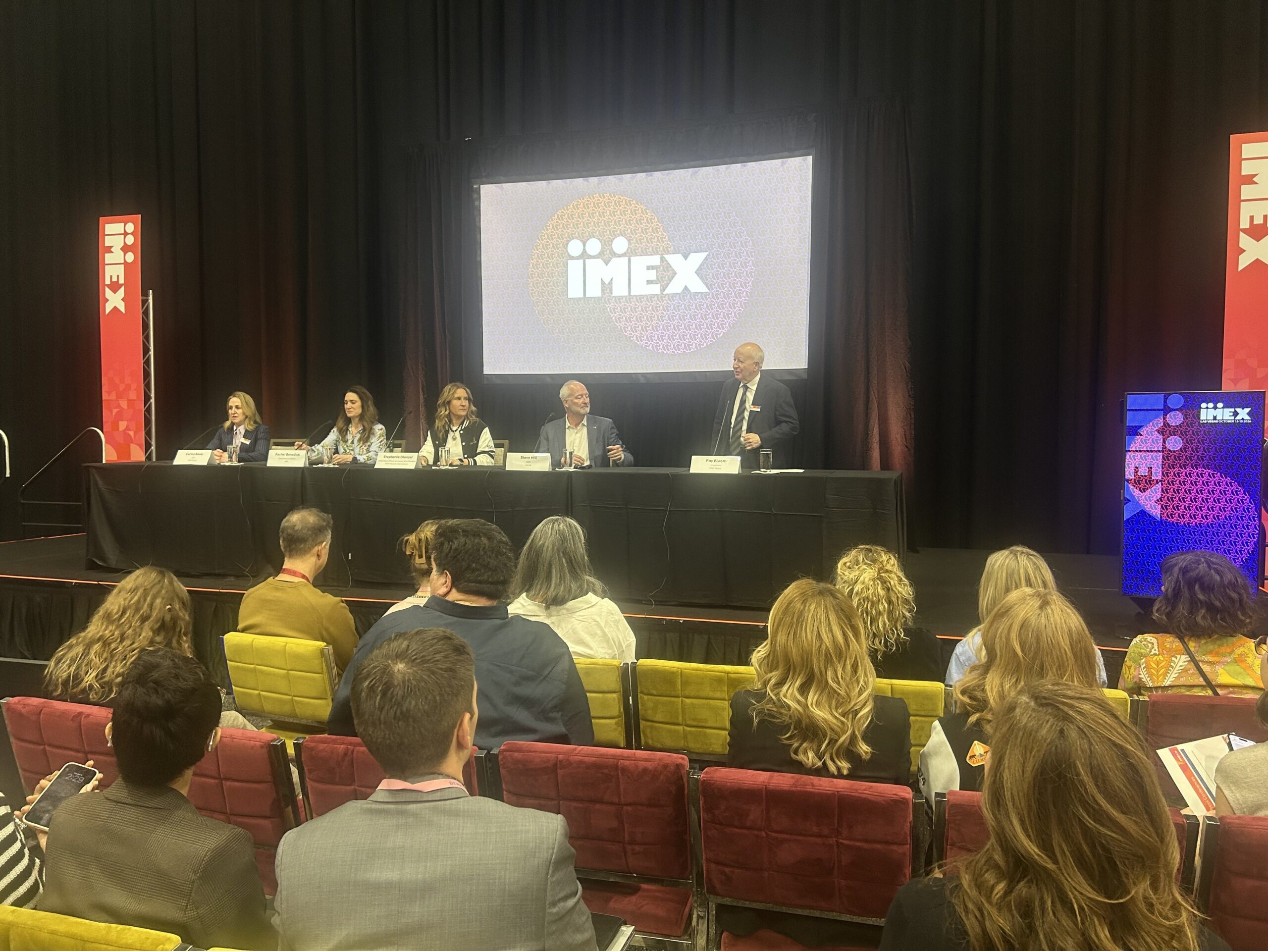 Five people on panel in front of group