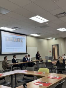 People talking to room of students