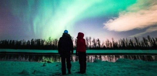 Two people standing in front of sky
